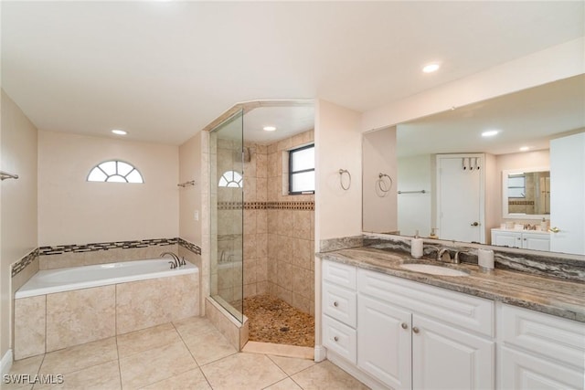 bathroom with tile patterned flooring, vanity, and shower with separate bathtub