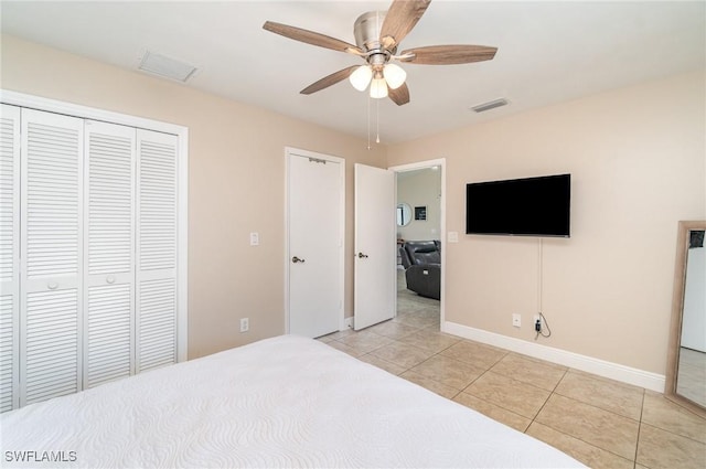 bedroom featuring a closet, ceiling fan, and light tile patterned flooring