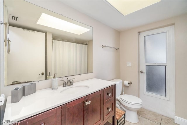 bathroom featuring tile patterned floors, vanity, and toilet