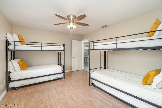 bedroom with ceiling fan and light hardwood / wood-style flooring