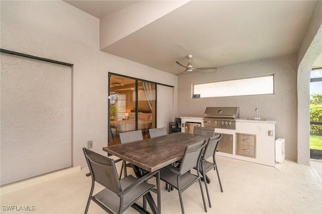 view of patio featuring a grill, ceiling fan, sink, and an outdoor kitchen