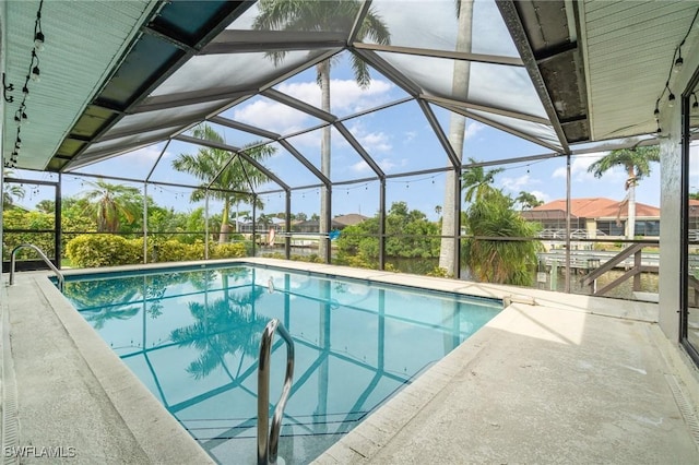 view of pool with a lanai and a patio