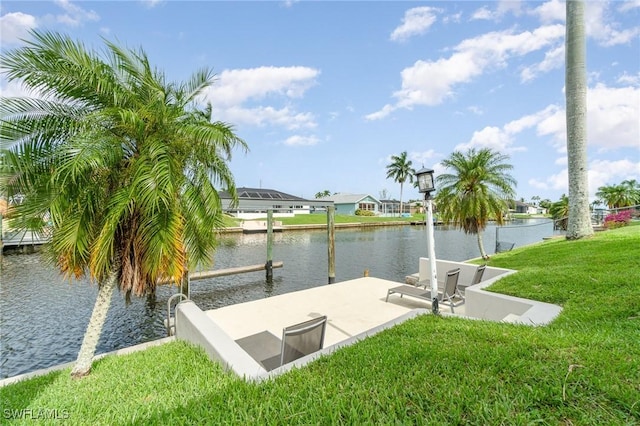 view of dock featuring a yard and a water view