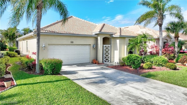 mediterranean / spanish house featuring a front lawn and a garage