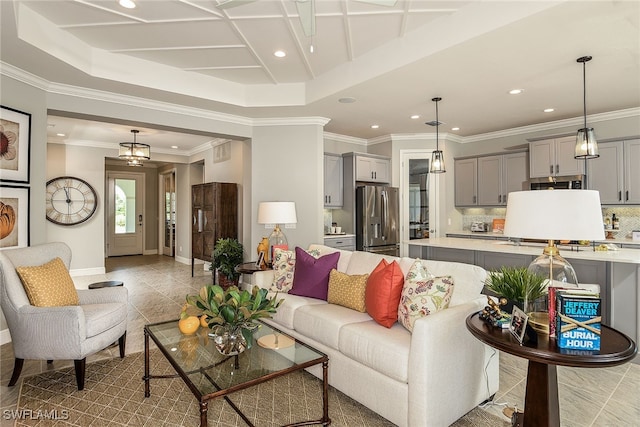 living room featuring a raised ceiling and crown molding