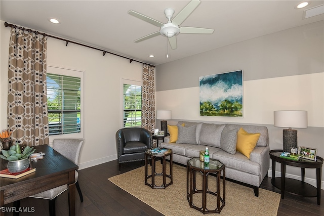 living room with ceiling fan and dark wood-type flooring