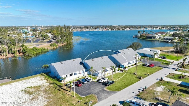 drone / aerial view featuring a water view and a residential view