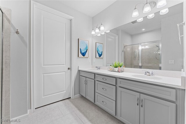 bathroom featuring tile patterned flooring, vanity, and an enclosed shower