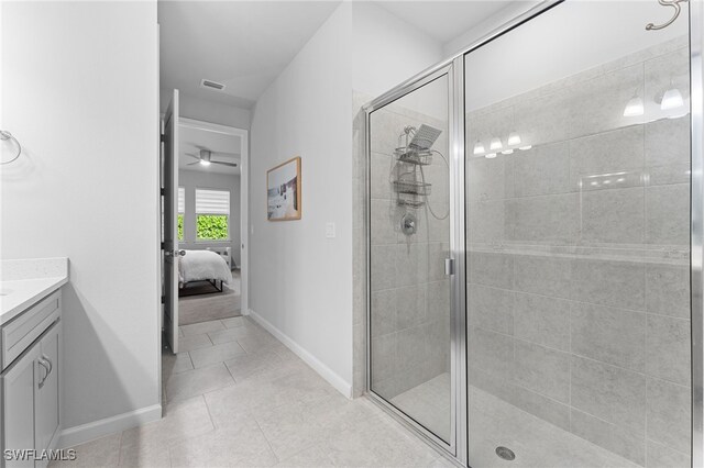 bathroom featuring tile patterned flooring, vanity, and an enclosed shower