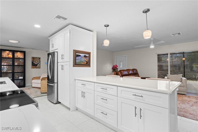 kitchen with pendant lighting, stainless steel refrigerator, white cabinets, electric range, and ceiling fan