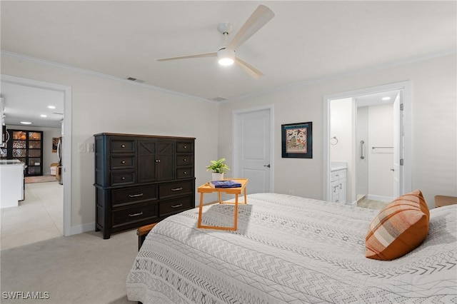 bedroom with ceiling fan, crown molding, light carpet, and ensuite bath