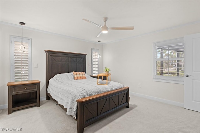 carpeted bedroom featuring crown molding and ceiling fan