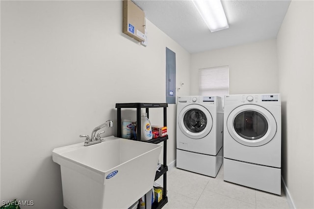 laundry room featuring sink, washing machine and clothes dryer, and electric panel