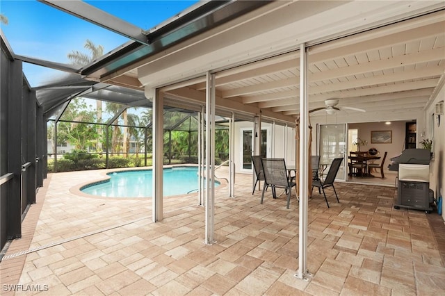 view of pool featuring ceiling fan, glass enclosure, and a patio area