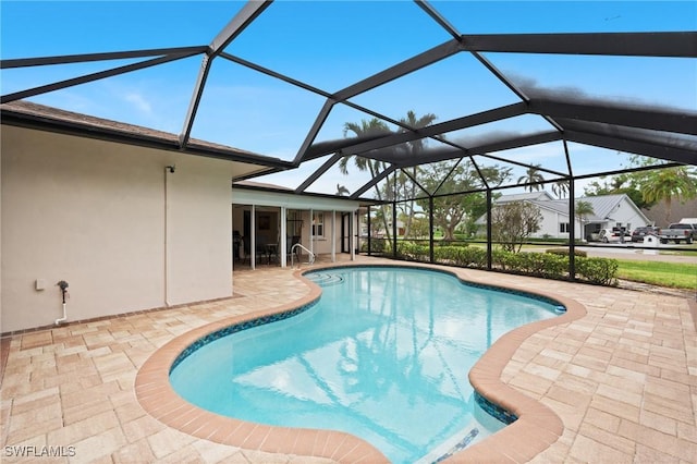 view of swimming pool with a patio and glass enclosure