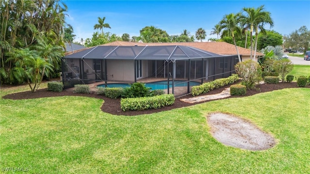 view of pool featuring a yard and glass enclosure