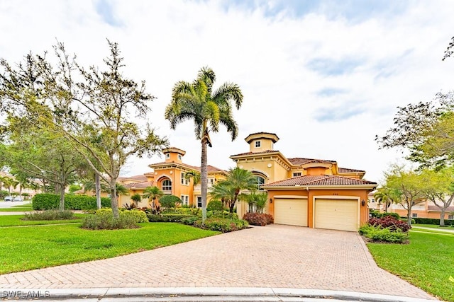 mediterranean / spanish-style home with a front lawn