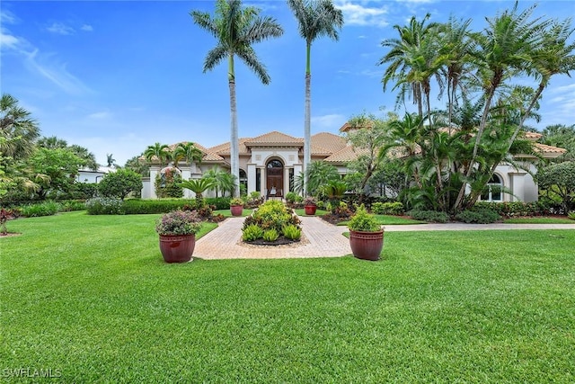 mediterranean / spanish-style home with a front lawn