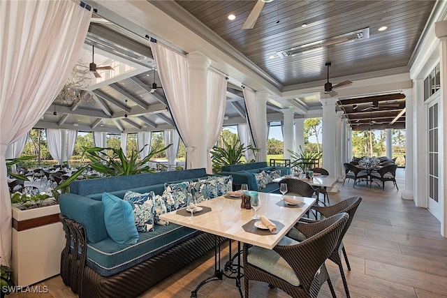 sunroom featuring ceiling fan and wooden ceiling