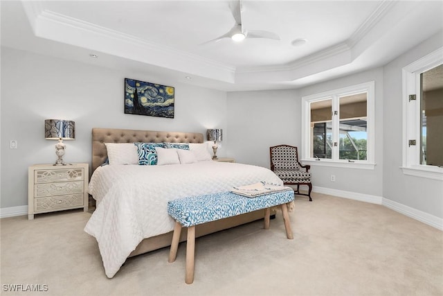 bedroom featuring ceiling fan, light colored carpet, ornamental molding, and a raised ceiling