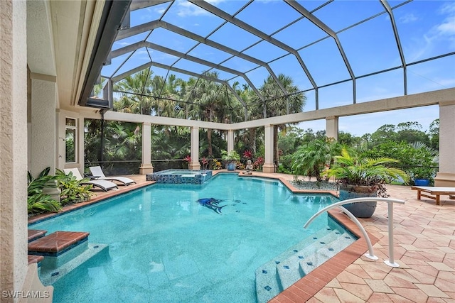 view of pool with a lanai, an in ground hot tub, and a patio