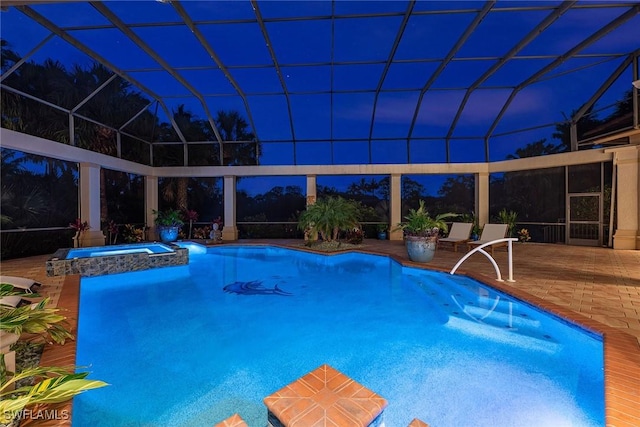 view of swimming pool with a lanai, an in ground hot tub, and a patio