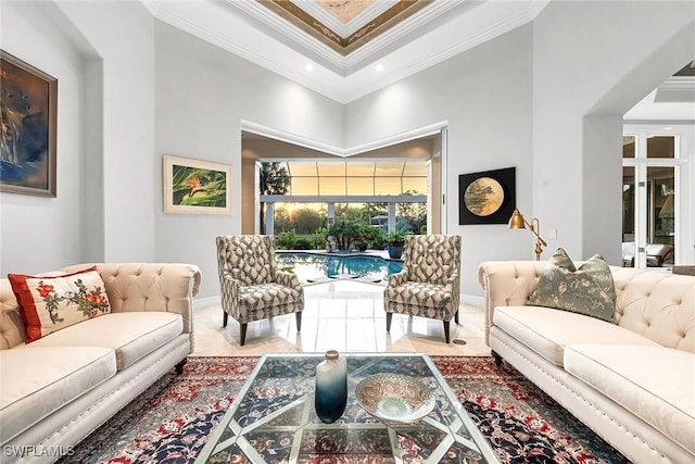 living room with a towering ceiling and crown molding