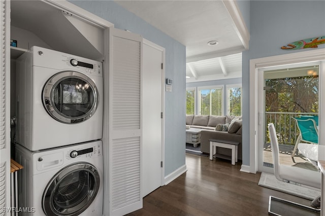 laundry room featuring dark hardwood / wood-style floors and stacked washer and clothes dryer