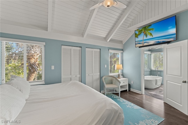 bedroom featuring ceiling fan, dark wood-type flooring, lofted ceiling with beams, wooden ceiling, and multiple closets