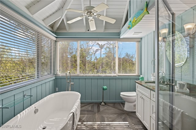 bathroom featuring parquet flooring, a tub to relax in, vanity, lofted ceiling with beams, and toilet