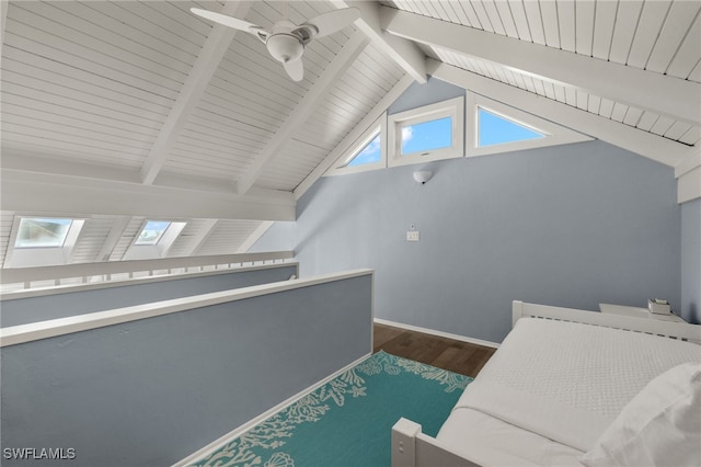 bonus room featuring dark hardwood / wood-style floors, lofted ceiling with skylight, and ceiling fan