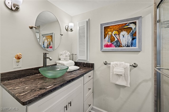 bathroom featuring vanity and an enclosed shower