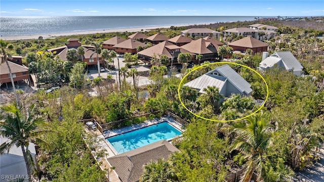 birds eye view of property with a water view and a view of the beach