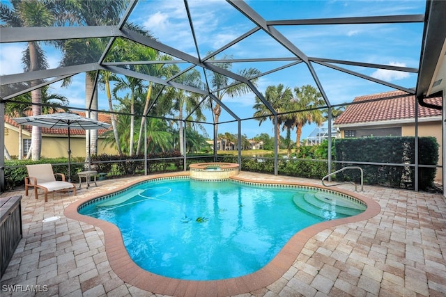 view of pool with a patio area, a lanai, and an in ground hot tub