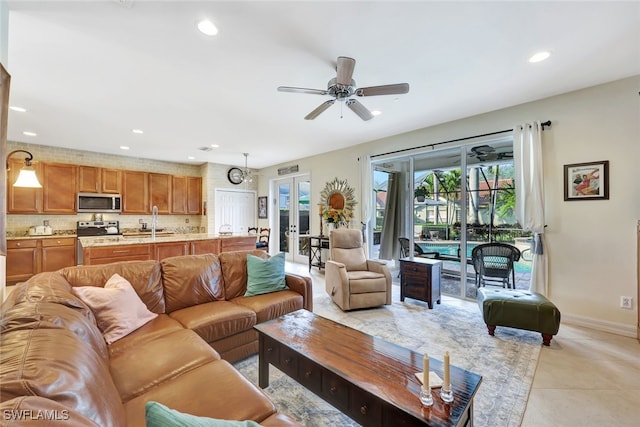 living room featuring ceiling fan, light tile patterned floors, and french doors