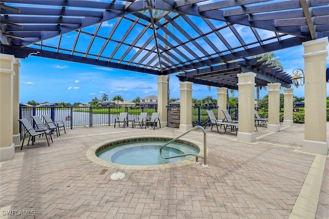 view of swimming pool with a water view, a pergola, a patio, and a community hot tub