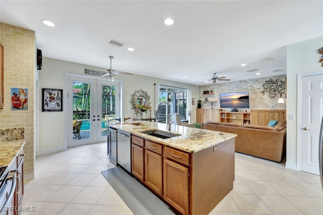 kitchen with dishwasher, sink, a kitchen island with sink, light tile patterned floors, and french doors