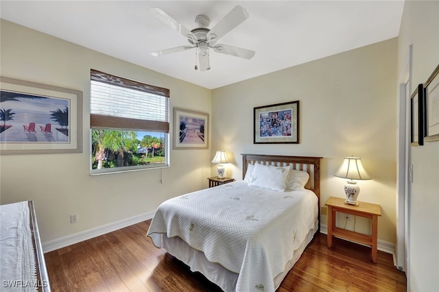 bedroom with ceiling fan and dark hardwood / wood-style floors