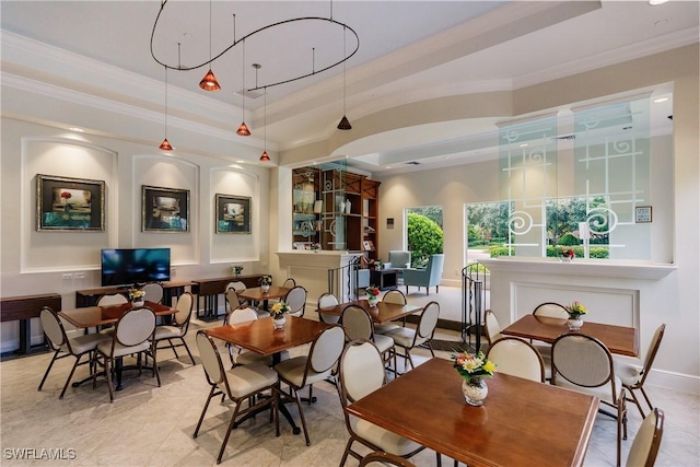 dining area with a tray ceiling and crown molding