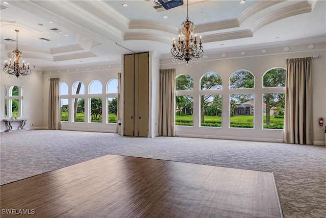 unfurnished living room with hardwood / wood-style floors, ornamental molding, and a notable chandelier