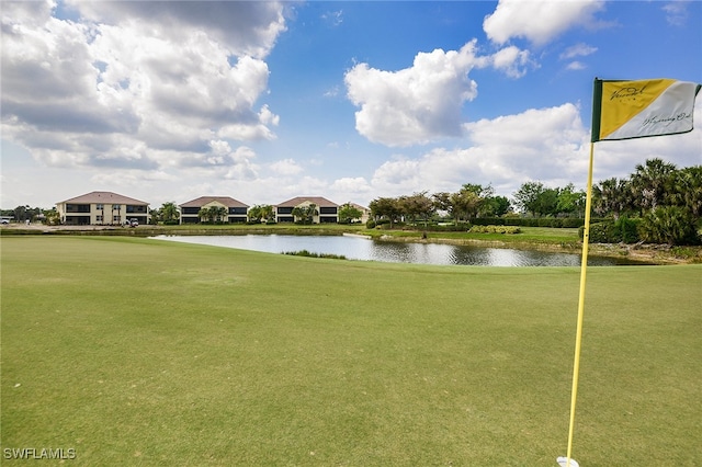 view of home's community featuring a water view and a lawn