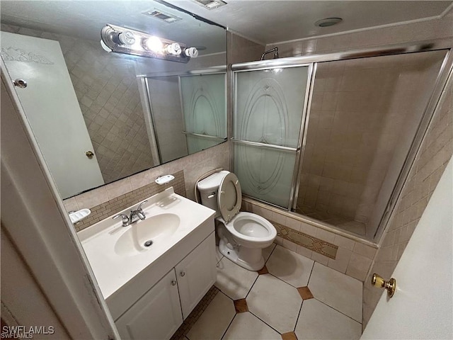 bathroom featuring tile patterned floors, an enclosed shower, toilet, decorative backsplash, and vanity