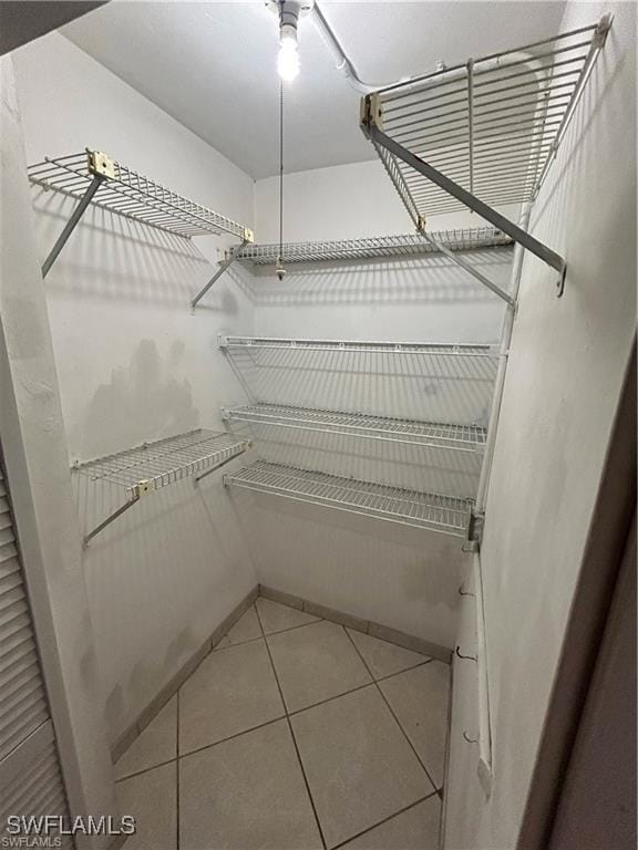 spacious closet featuring light tile patterned flooring