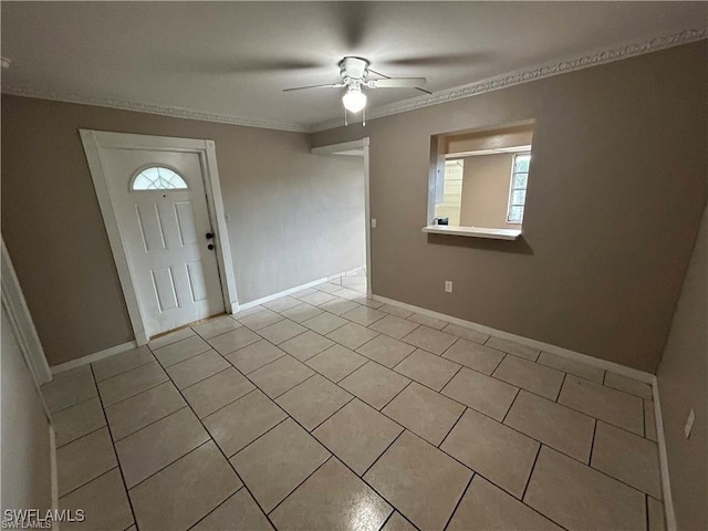 entrance foyer with ceiling fan, light tile patterned floors, and ornamental molding