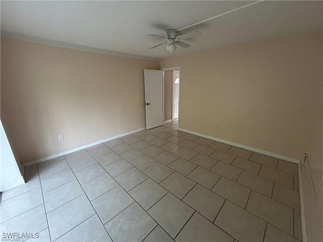 empty room featuring ceiling fan and light tile patterned floors