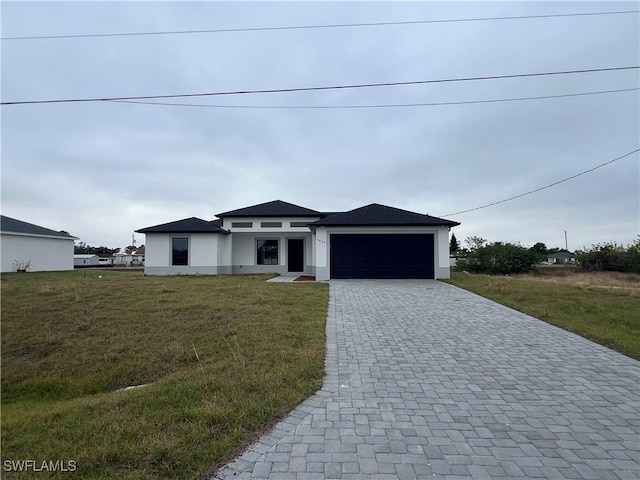 view of front of home featuring a garage and a front lawn