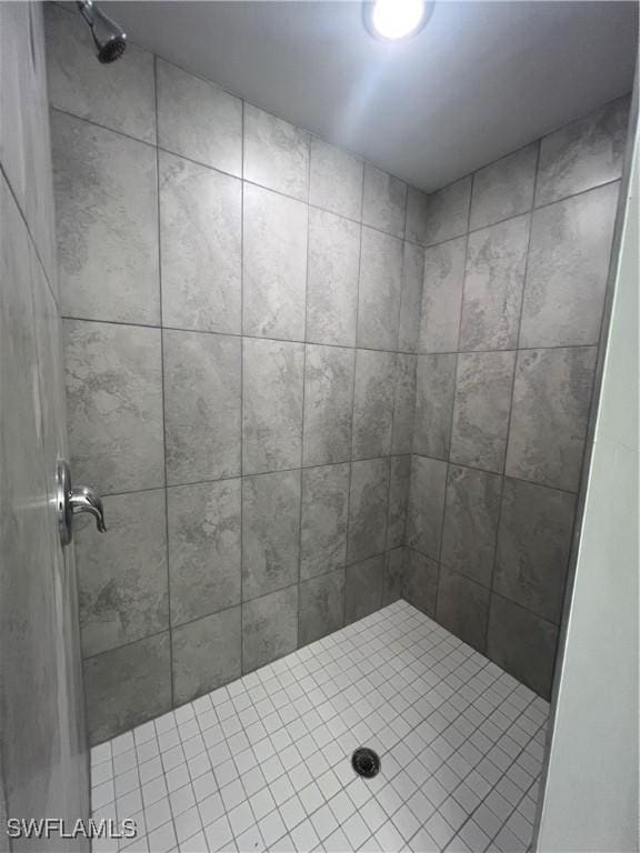 bathroom with a tile shower