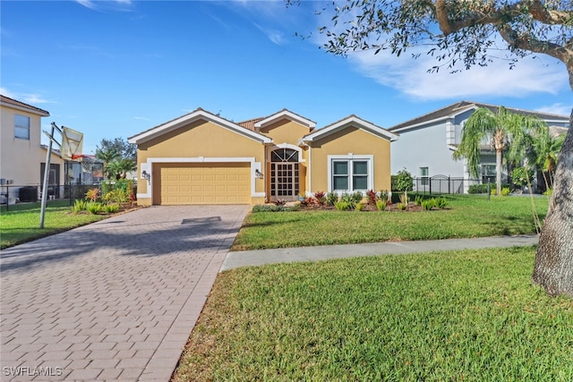 view of front of property with a garage and a front lawn