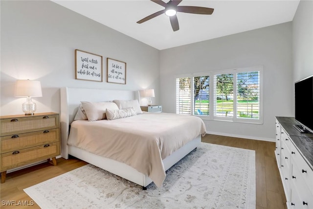 bedroom with ceiling fan and light wood-type flooring