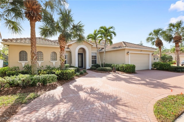 mediterranean / spanish house featuring a garage